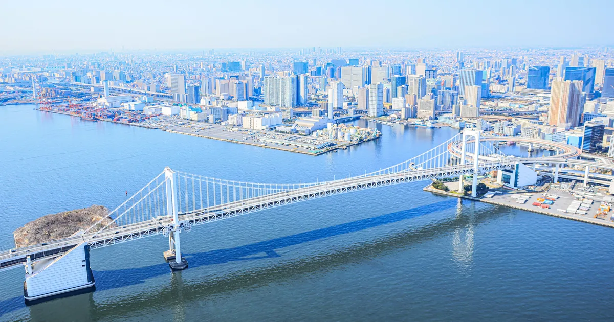 The Rainbow Bridge crossing Tokyo Bay with the towers of central Tokyo behind, seen from a private helicopter