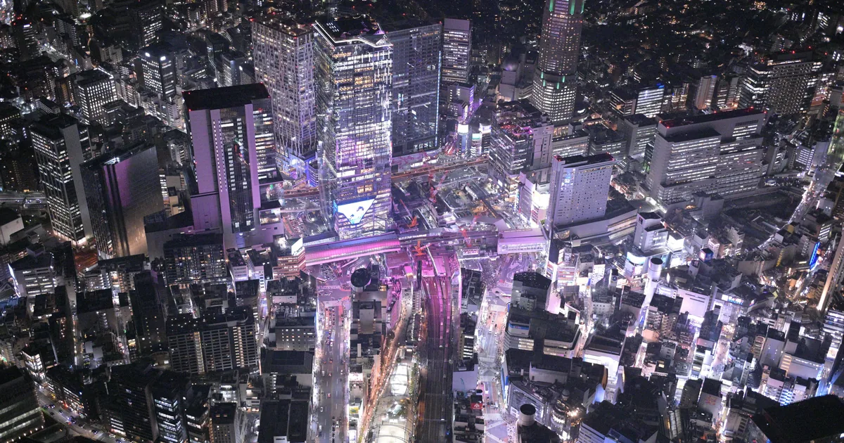 Shibuya's lit streets and towers seen from directly above at night on a Tokyo night helicopter tour
